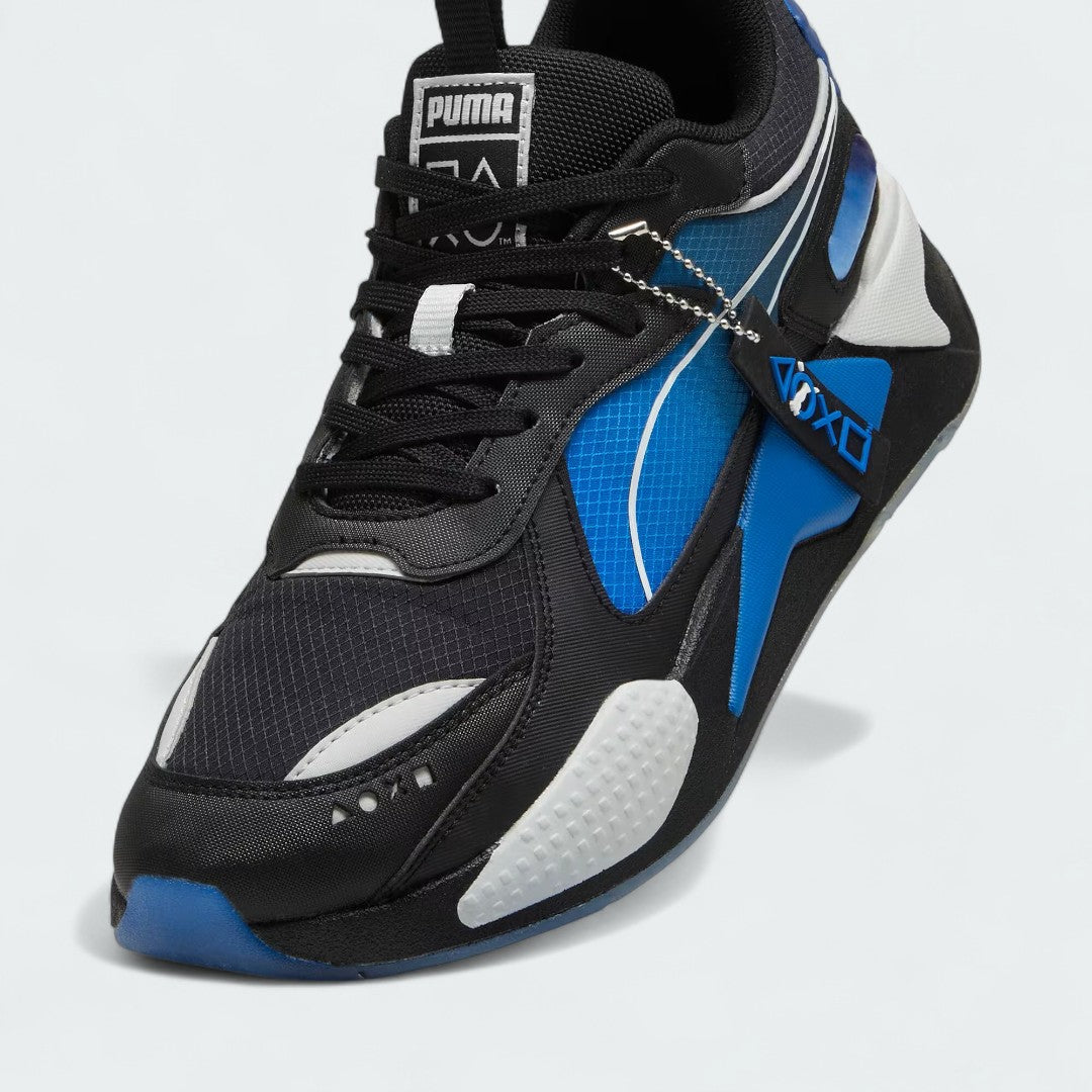 Close-up zoom on the front of the Puma RS-X x PlayStation Unisex trainers, showing the mesh and suede textures, lace-up system, and co-branded lace dubrae.