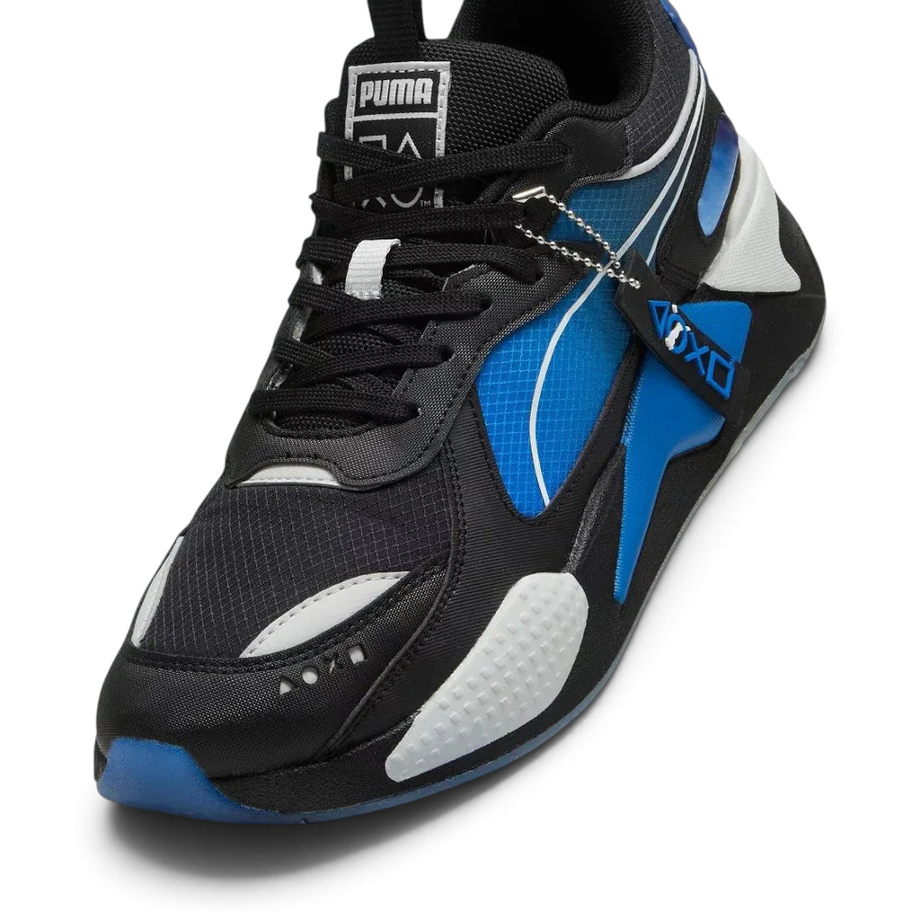 Close-up zoom on the front of the Puma RS-X x PlayStation Unisex trainers, showing the mesh and suede textures, lace-up system, and co-branded lace dubrae.