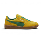 Highlights the high-velocity sweep of the green leather Formstrip, showing the professional, rich sheen of the Pelé Yellow suede upper and the shining gold foil Palermo branding flap.