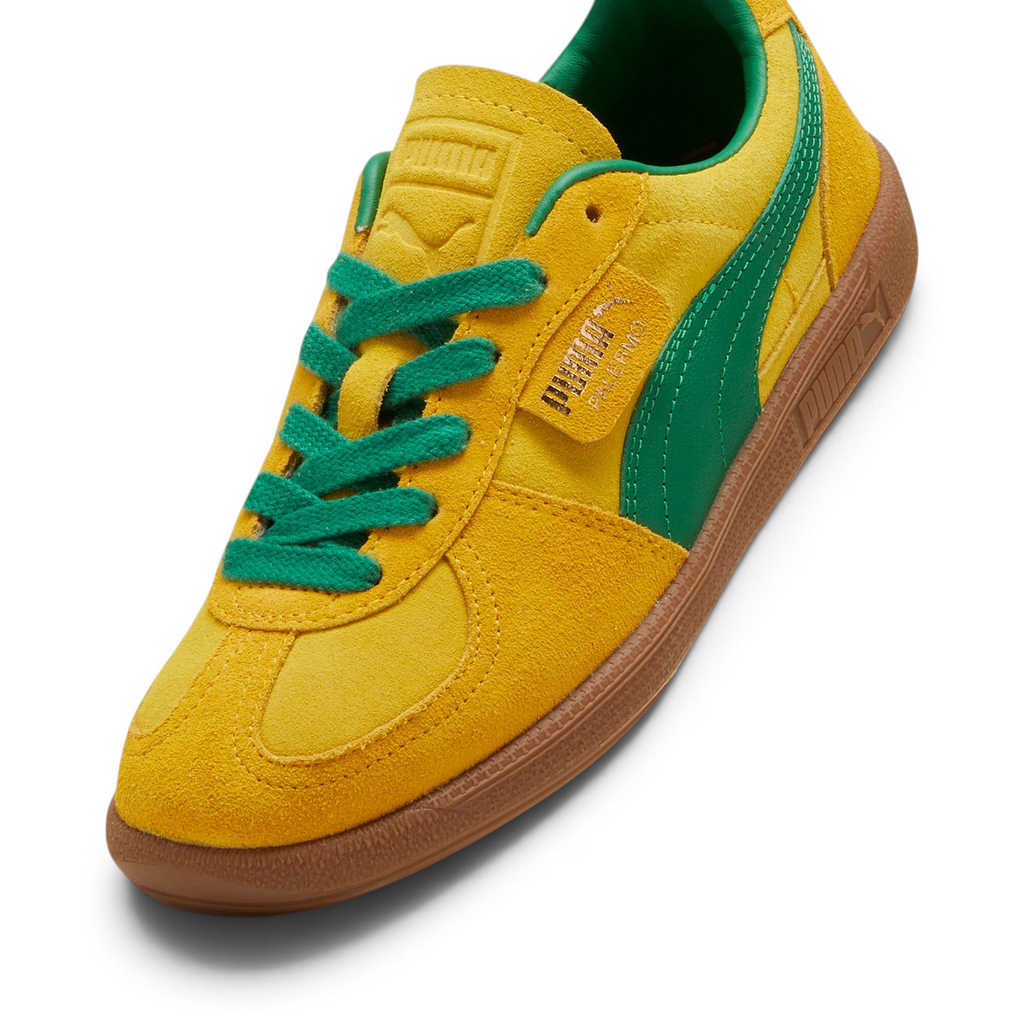 Details the premium dual-stitching lines crossing the velvety suede toe box cap and the precision lacing configuration eyelets.