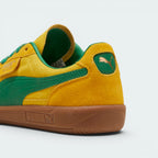 Focuses on the contoured shape of the green leather heel tab, showing the clean, screen-printed PUMA cat logo sitting above the texturized gum sole spine.