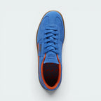 Focuses on the locked-in traditional lacing layout, showing the clean alignment of the debossed suede tongue and the classic low-profile symmetry framing the toe box.