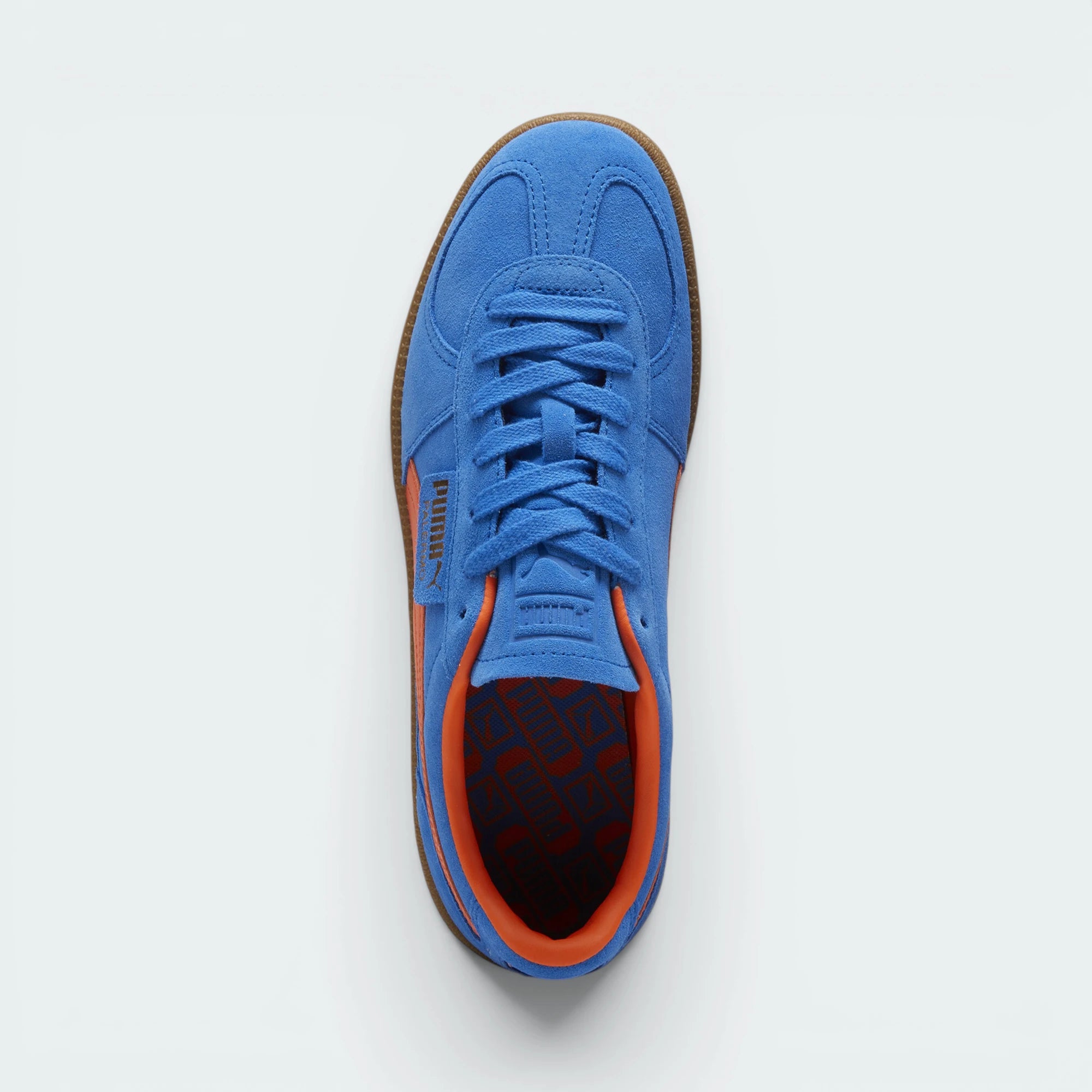Focuses on the locked-in traditional lacing layout, showing the clean alignment of the debossed suede tongue and the classic low-profile symmetry framing the toe box.