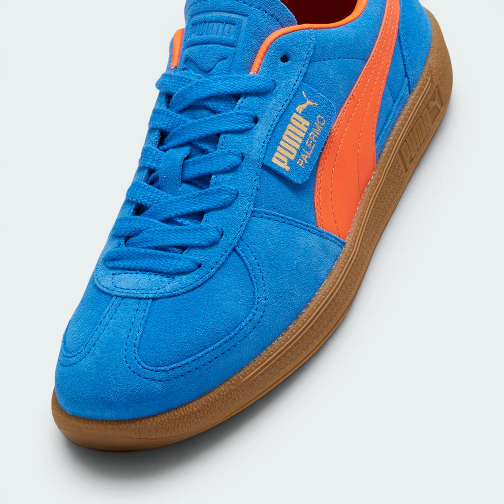 Details the premium dual-stitching lines crossing the velvety suede toe box cap and the precision lacing configuration eyelets.