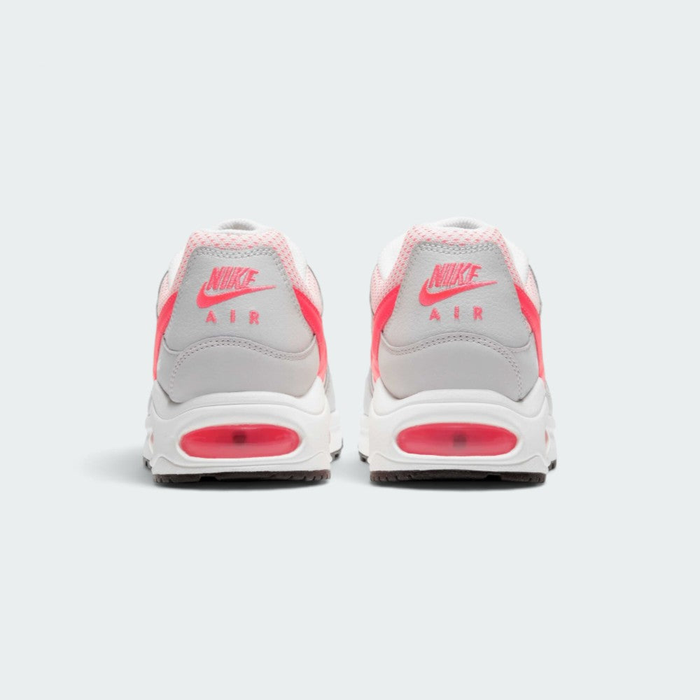 Focuses on the rear profile, highlighting the White leather heel counters stamped with Hyper Punch "NIKE AIR" logos and the wide stack of the foam midsole base.