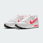 Emphasising the low-cut, layered retro running stance of the trainers and the vivid contrast between the white uppers and popping Hyper Punch Swooshes.