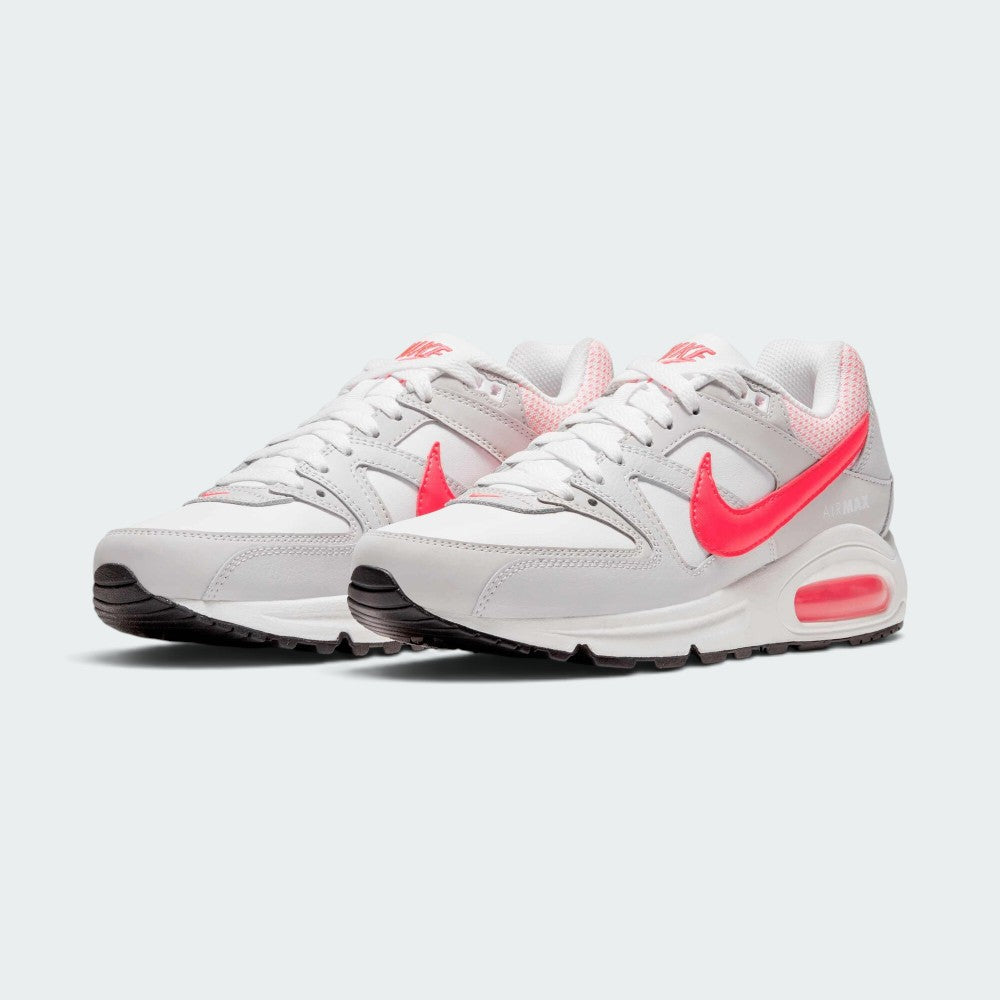 Emphasising the low-cut, layered retro running stance of the trainers and the vivid contrast between the white uppers and popping Hyper Punch Swooshes.