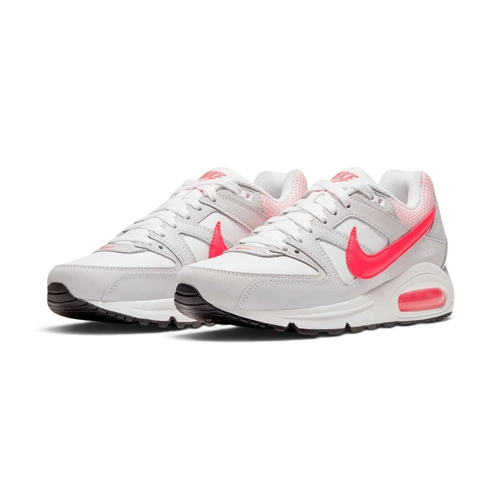 Emphasising the low-cut, layered retro running stance of the trainers and the vivid contrast between the white uppers and popping Hyper Punch Swooshes.