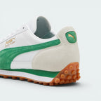 Focuses on the contoured shape of the rear heel counter, highlighting the off-white suede backing patch embellished with a green screen-printed PUMA Cat logo.