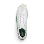 Overhead look showcasing the clean white leather upper, off-white suede T-toe mudguard overlay, central lacing system with flat white laces, embossed white leather tongue, green suede side Formstrip accents, and forest green padded sockliner with white PUMA branding.
