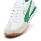 Highlights the forefoot and midfoot details from an angled three-quarter perspective, showcasing the textured off-white suede T-toe wrap, white leather vamp, flat laces through punched eyestays, embossed leather tongue crest, metallic gold foil "PUMA Easy Rider" branding, and lush green suede Formstrip.