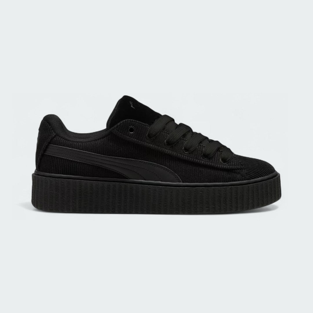 Puma Creeper Phatty x Fenty Women's trainers in black corduroy, side profile showing the chunky platform sole and classic Puma Formstrip.