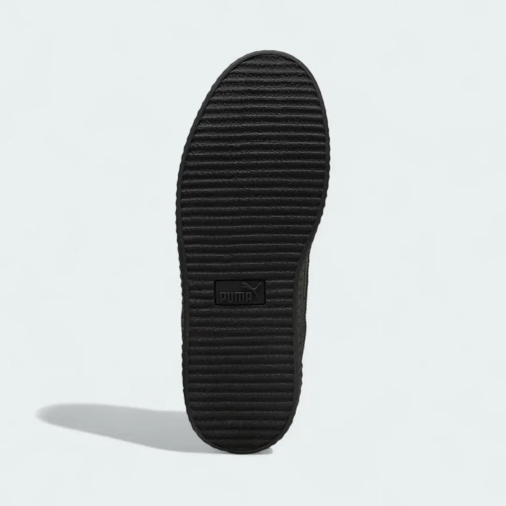 View of the outsole of the Puma Creeper Phatty x Fenty Unisex trainers, showing the thick rubber platform sole and tread pattern.