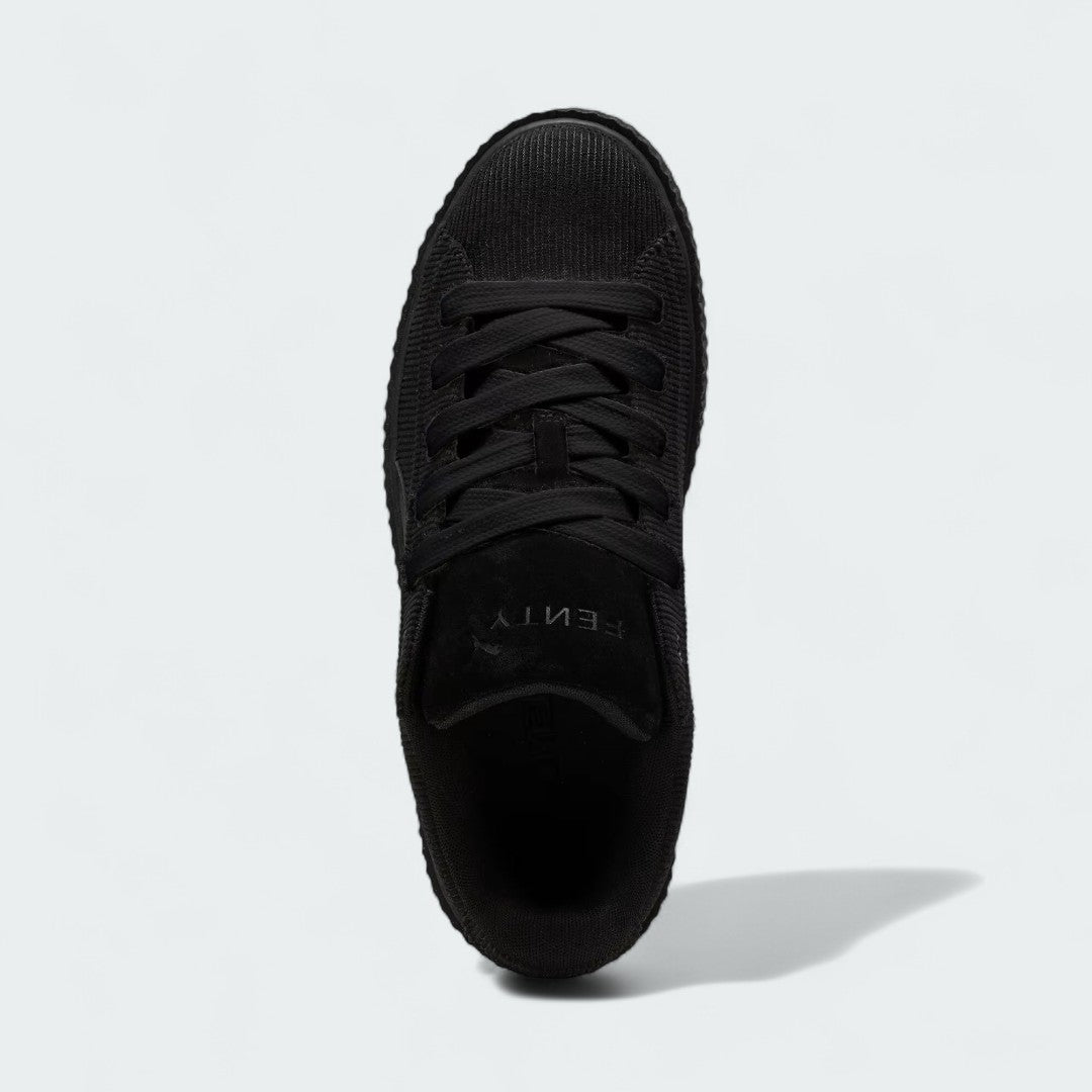Top-down view of a pair of Puma Creeper Phatty x Fenty Women's trainers in black, highlighting the corduroy texture and lace-up closure.