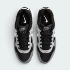 Focuses on the locked-in lace closure layout, the technical black mesh on the toe box, and the classic branded tongue patches.