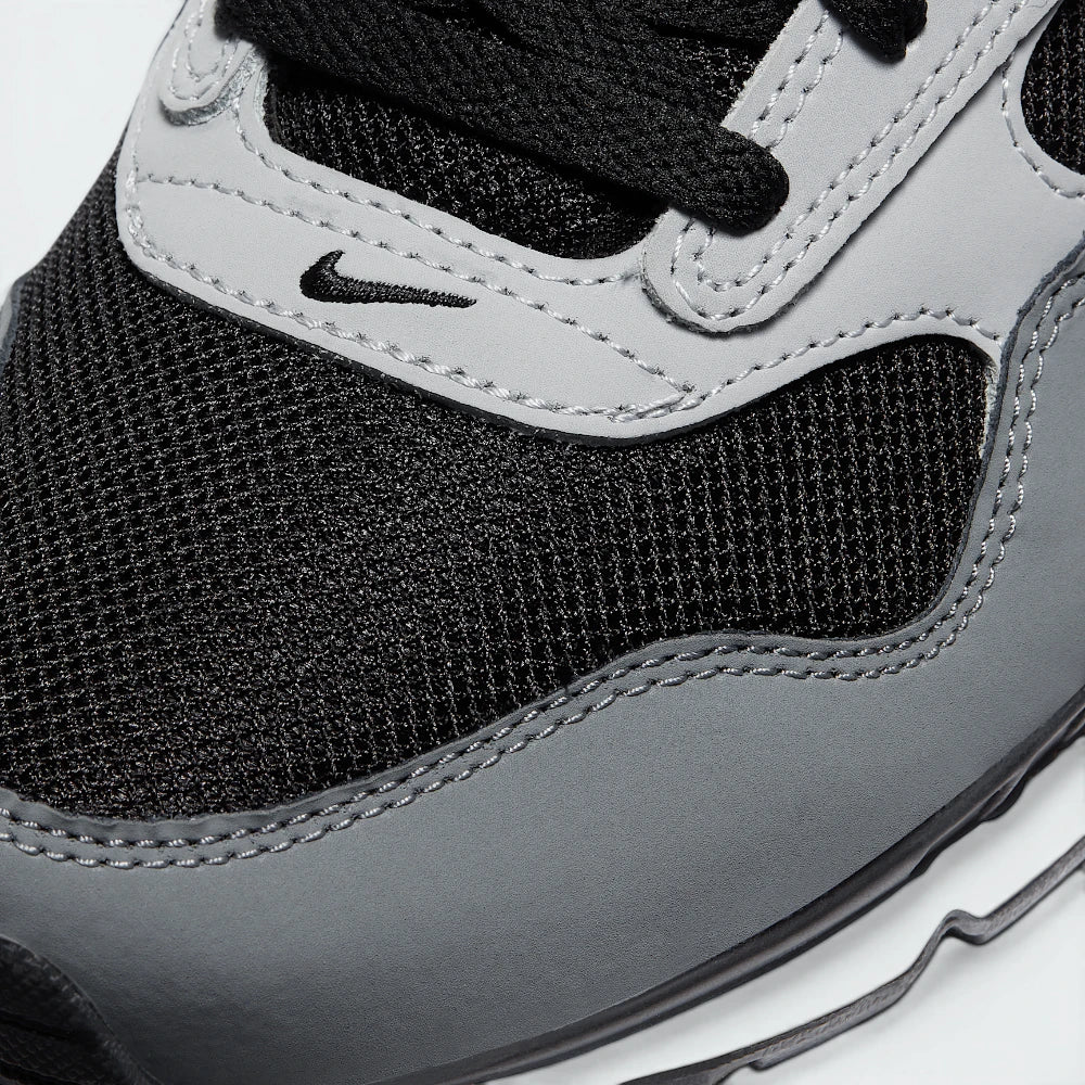 Details the high-definition textile weave on the toe box and the precision double-stitching around the front suede guards.