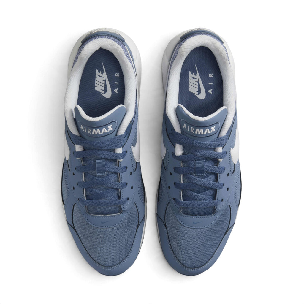 Overhead view of both sneakers showing the mesh forefeet, central lacing systems, and navy blue insoles printed with white Nike Air branding.