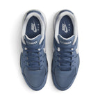 Overhead view of both sneakers showing the mesh forefeet, central lacing systems, and navy blue insoles printed with white Nike Air branding.