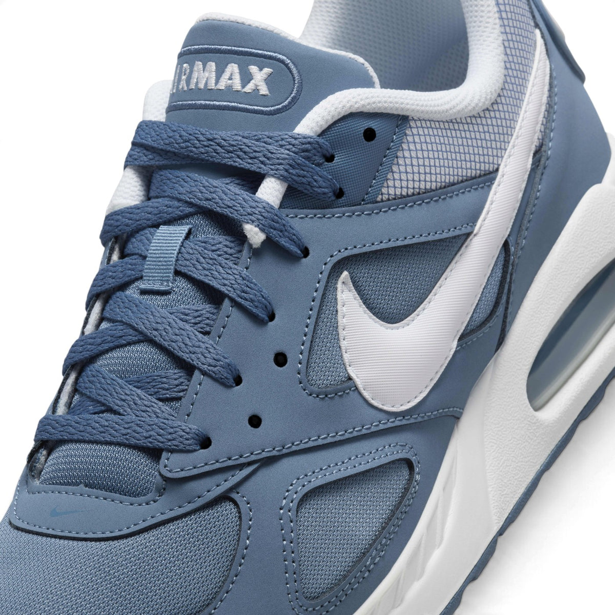 Macro focus on the forefoot and eyestay, detailing the airy mesh toe box, embroidered AIRMAX tongue label, and white side Swoosh.