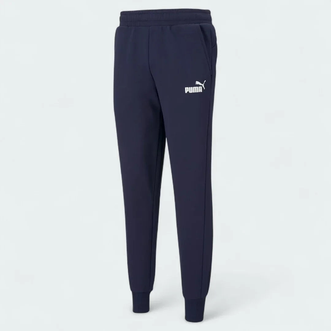 Puma Essential Logo Pants Men's in navy fleece, front view showing the elastic waistband, drawcord, and a white Puma Cat Logo on the thigh.