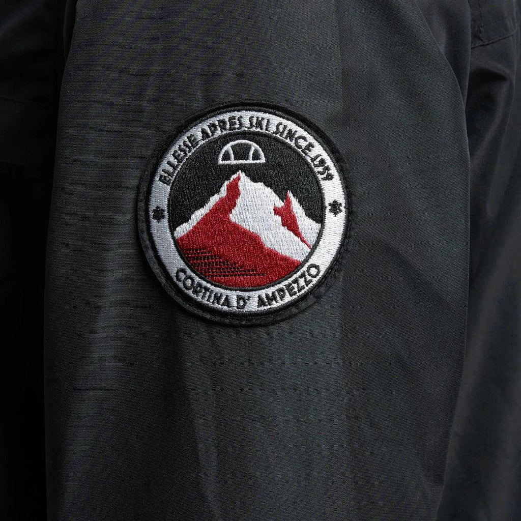 Close-up zoom on the fabric of the Ellesse Mont 2 Overhead Jacket, showing the textured marl finish and the embroidered or printed Ellesse logo.