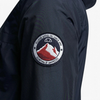 Close-up zoom on the fabric of the Ellesse Mont 2 Overhead Anorak Jacket, showing the textured finish and the embroidered or printed Ellesse logo.