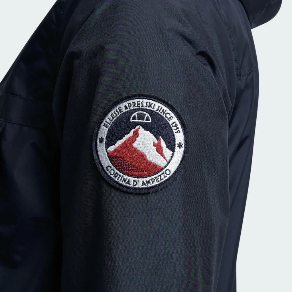 Close-up zoom on the fabric of the Ellesse Mont 2 Overhead Anorak Jacket, showing the textured finish and the embroidered or printed Ellesse logo.