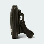 Ellesse Templeton Crossbody Bag in black, side profile showing its compact depth and the strap attachment points.