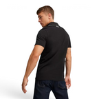 Trade Sports Puma x Ferrari black piqué polo shirt viewed from the back on a male model wearing dark denim jeans