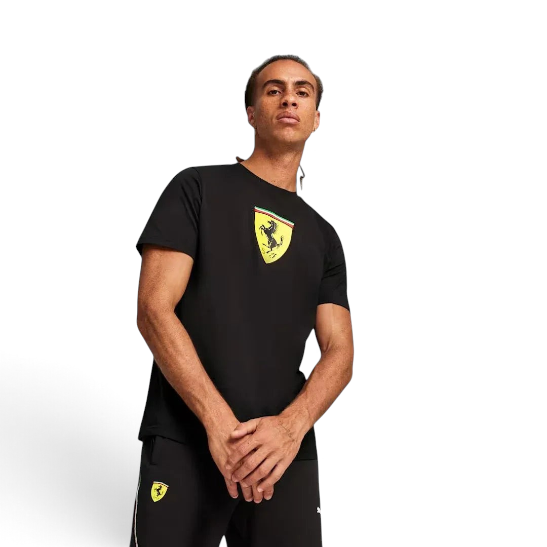 Puma x Ferrari Race Big Shield T-Shirt Men's in black, front view shown on a model showing a classic crew neck and a large, bold Ferrari Scudetto badge on the chest. Main image