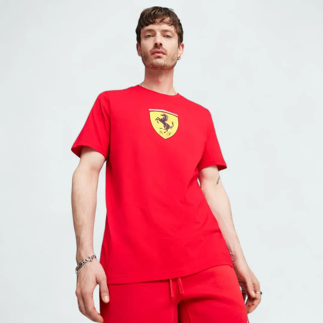 Puma x Ferrari Race Big Shield T-Shirt Men's in red, front view model showing a classic crew neck and a large, bold Ferrari Scudetto badge on the chest. Main image