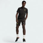 Puma x Ferrari Race Shorts Men's in black, front view showing model in a pose showing comfort and style