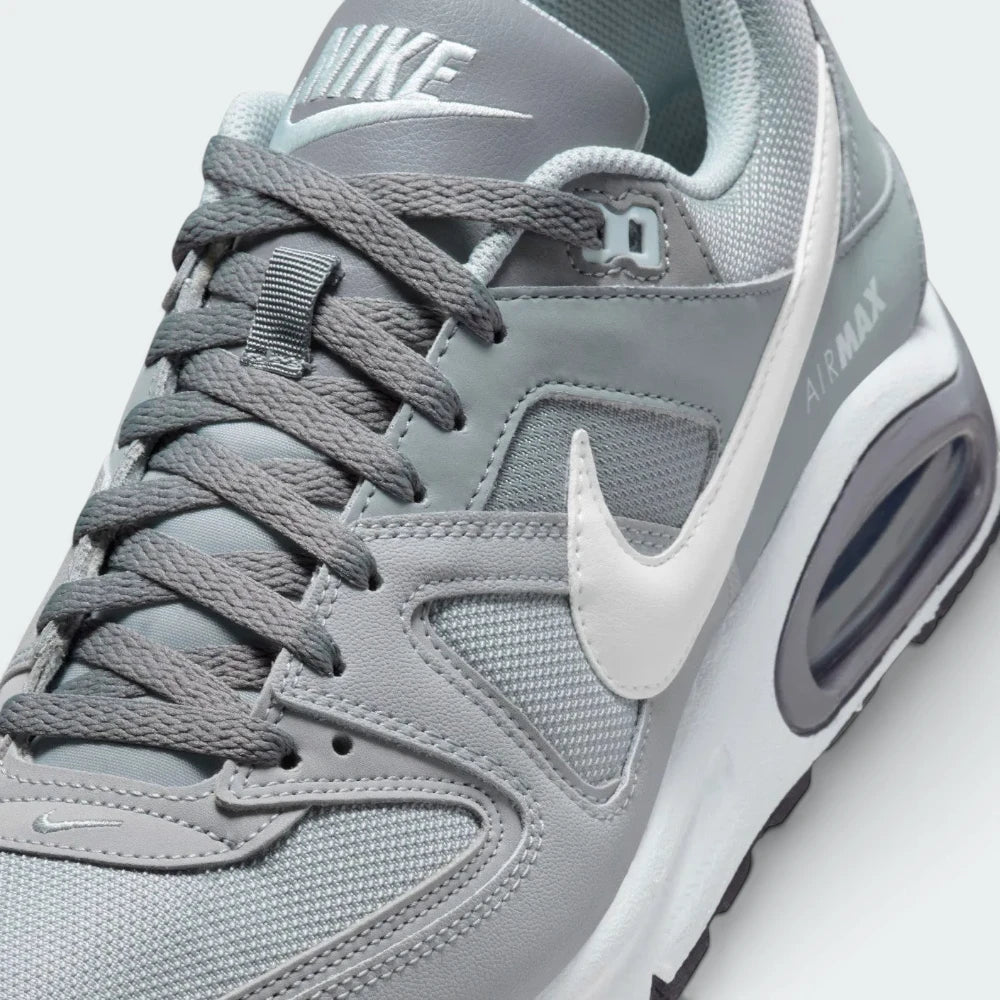 Details the premium precision of the stitched overlays wrapping the front toe cap to defend against debris, showcasing the breathable mesh ventilation pores up close.