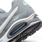 Highlights the "unreal" clean finish where the thick foam cushioning carrier securely bonds to the high-traction rubber base, framing the iconic lines of the heel Air pocket.