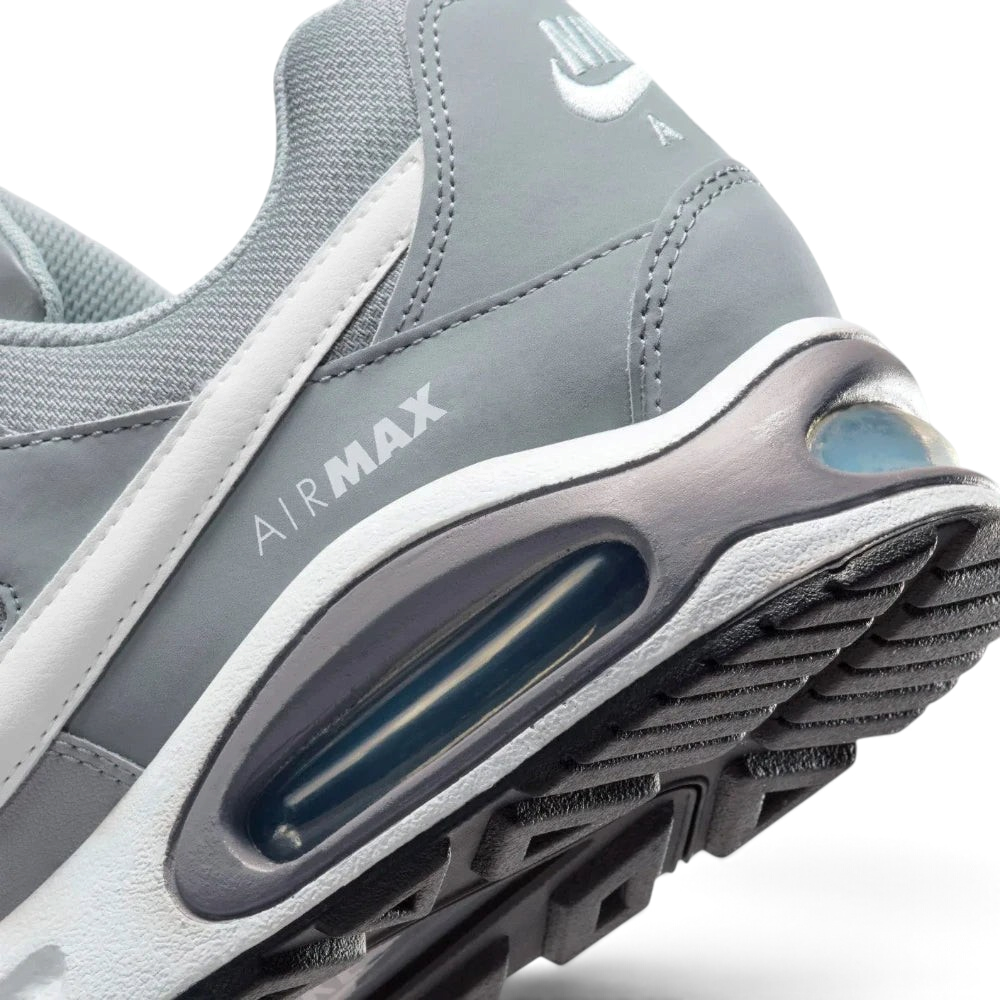 Highlights the "unreal" clean finish where the thick foam cushioning carrier securely bonds to the high-traction rubber base, framing the iconic lines of the heel Air pocket.