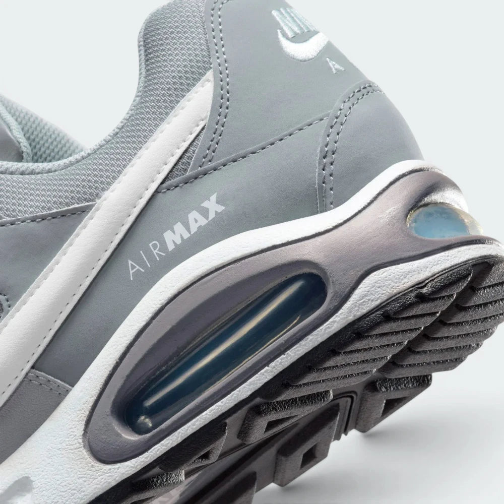 Highlights the "unreal" clean finish where the thick foam cushioning carrier securely bonds to the high-traction rubber base, framing the iconic lines of the heel Air pocket.
