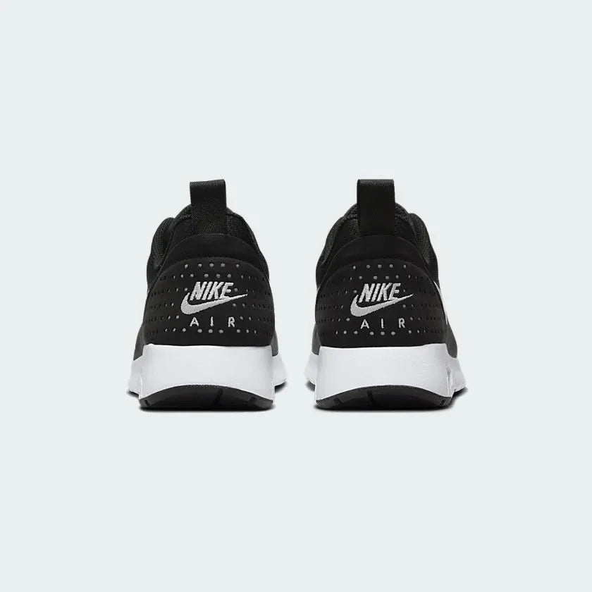 Rear view of the Nike Air Max Tavas Men's black trainers, focusing on the visible Max Air unit in the heel and subtle branding.