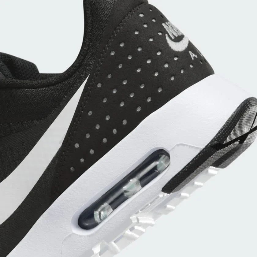 Detailed zoom on the outsole and midsole of the Nike Air Max Tavas Men's black trainers, highlighting the cushioned foam and durable rubber outsole.
