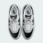 Top-down view of a pair of Nike Air Max Command Premium Women's trainers in black, highlighting their classic silhouette and lace-up closure.