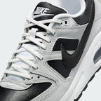Close-up zoom on the front of the Nike Air Max Command Premium Women's black leather trainers, showing the perforated toe box, lacing system, and texture of the leather upper.