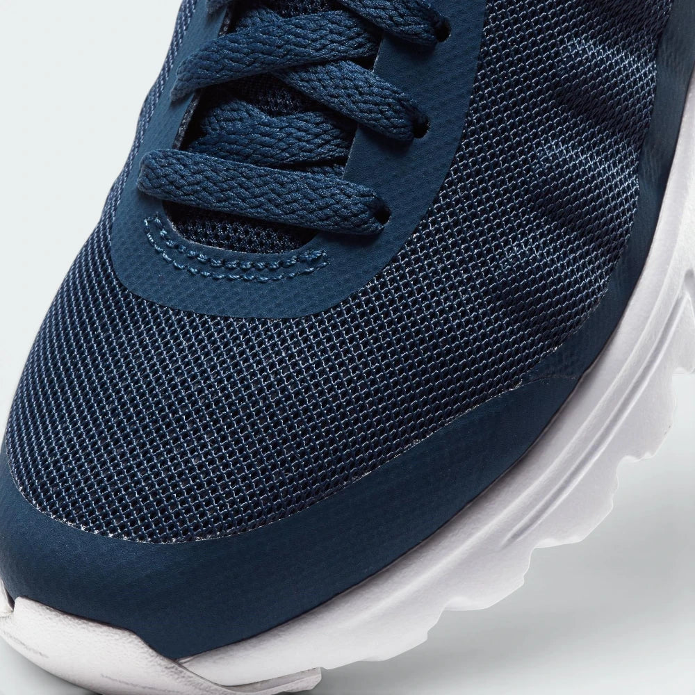 Details the premium seamless overlays wrapping the front toe scuff zone and the precision layout of the lacing eyelets.