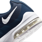 Highlights the "unreal" clean finish where the lightweight navy cushioning wall bonds securely to the high-traction waffle synthetic base.