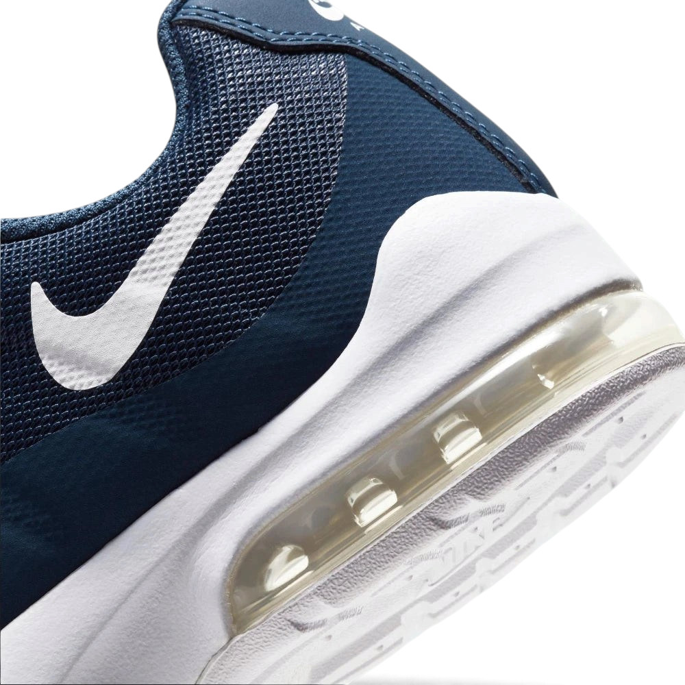 Highlights the "unreal" clean finish where the lightweight navy cushioning wall bonds securely to the high-traction waffle synthetic base.