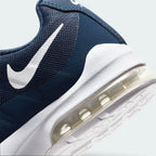 Highlights the "unreal" clean finish where the lightweight navy cushioning wall bonds securely to the high-traction waffle synthetic base.