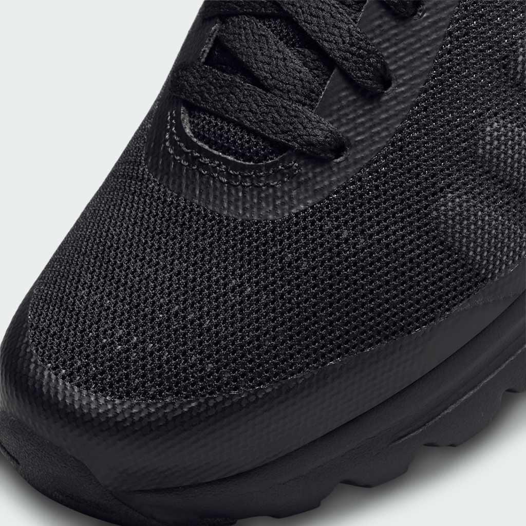 Close-up of Nike Air Max Invigor Juniors Trainers Black 749572-003 laces, tongue logo, and mesh texture