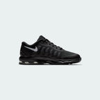 Nike Air Max Invigor Children's trainers in black with grey accents, side profile showing mesh upper, prominent visible Max Air unit in the heel, and sleek silhouette.