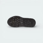View of the black rubber outsole, showcasing the modified waffle traction pattern for multi-surface grip.
