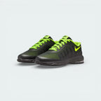 Angled shot of both Nike Invigor trainers, showcasing the lightweight silhouette and the striking neon Volt Swoosh.