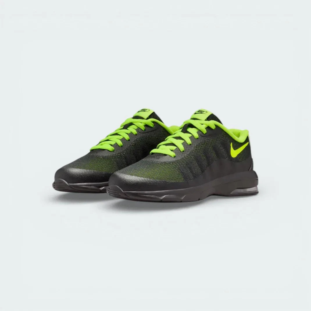 Angled shot of both Nike Invigor trainers, showcasing the lightweight silhouette and the striking neon Volt Swoosh.