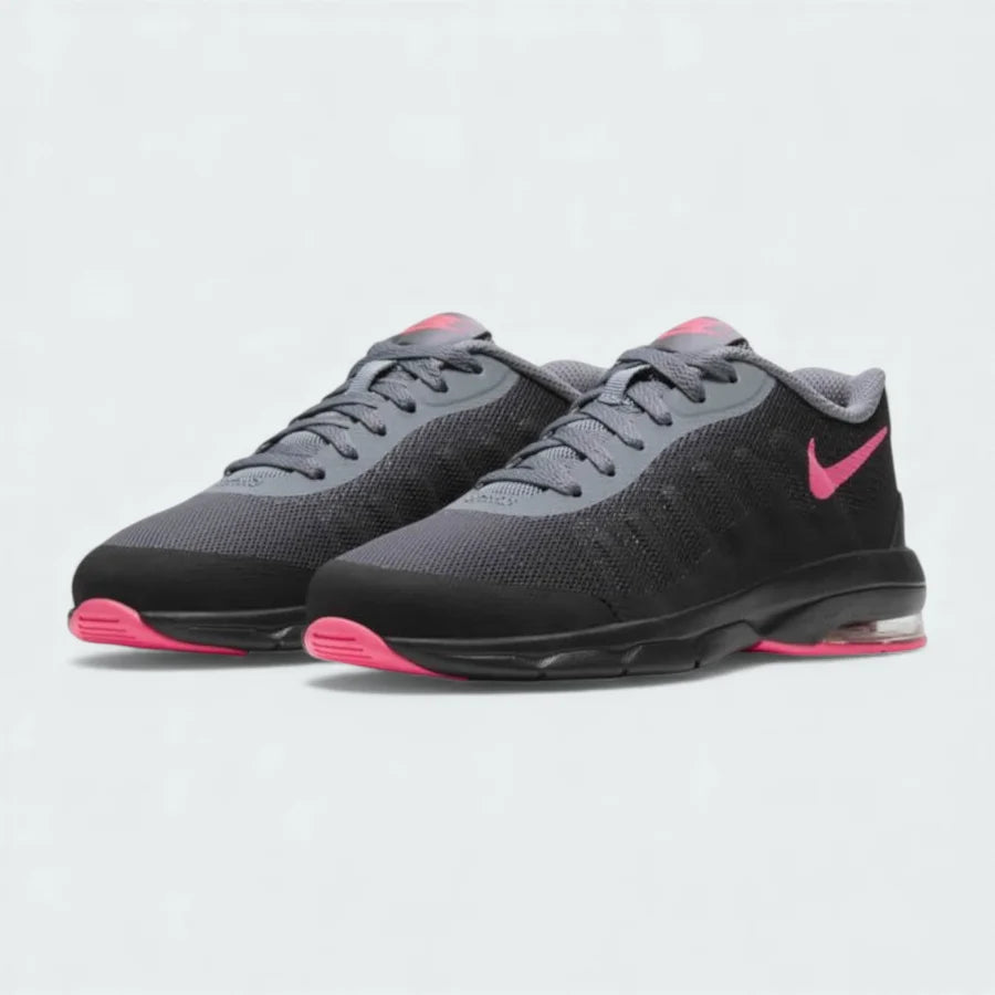 Angled view of two Nike Air Max Invigor Children's trainers in black and pink, side by side, showcasing their modern aesthetic and lightweight construction.